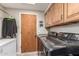 Well-equipped laundry room with modern appliances, ample cabinetry, and convenient access to the exterior at 6133 E Saddleback St, Mesa, AZ 85215