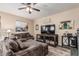 Living room with wood-look tile flooring, media center, and comfortable seating at 6133 E Saddleback St, Mesa, AZ 85215