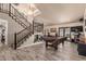 Open-concept living room with wooden floors, staircase, and a billiards table at 6133 E Saddleback St, Mesa, AZ 85215