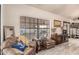 Cozy living room with wood-look tile flooring, a large window, and comfortable seating at 6133 E Saddleback St, Mesa, AZ 85215