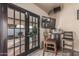 Cozy room with french doors leading to an outdoor space and a bar table at 6133 E Saddleback St, Mesa, AZ 85215
