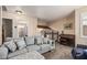 Inviting living room showcasing a comfortable sofa, staircase, piano, and doorway to the bathroom at 6133 E Saddleback St, Mesa, AZ 85215