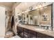 This primary bathroom features a double sink vanity, a walk-in shower and tiled floors at 6133 E Saddleback St, Mesa, AZ 85215
