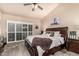 Relaxing main bedroom with a king bed, ceiling fan, and an abundance of natural light at 6133 E Saddleback St, Mesa, AZ 85215