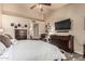 Relaxing main bedroom with a king bed, ceiling fan, dresser and TV at 6133 E Saddleback St, Mesa, AZ 85215