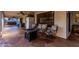 Relaxing covered patio with an outdoor seating area and stone pavers at 6133 E Saddleback St, Mesa, AZ 85215