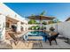Backyard swimming pool surrounded by patio, lounge chairs, and lush landscaping at 6133 E Saddleback St, Mesa, AZ 85215