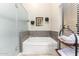 Bright bathtub with shower and storage rack at 650 E Silver Creek Rd, Gilbert, AZ 85296