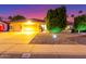 Charming single-story home featuring a tile roof and a well-lit, meticulously maintained front yard at dusk at 650 E Silver Creek Rd, Gilbert, AZ 85296