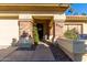 Charming home entrance featuring a brick-accented porch and welcoming 'hello' wreath on the front door at 650 E Silver Creek Rd, Gilbert, AZ 85296