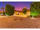 Well-manicured front yard with mature trees and a home exterior under a captivating dusk sky at 650 E Silver Creek Rd, Gilbert, AZ 85296