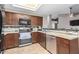 Bright kitchen featuring stainless steel appliances and tile backsplash at 650 E Silver Creek Rd, Gilbert, AZ 85296