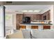 Open kitchen with dark cabinets, a breakfast bar, and modern appliances at 650 E Silver Creek Rd, Gilbert, AZ 85296