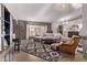 Spacious living room featuring a brick accent wall, modern furnishings, and ample natural light for comfort at 650 E Silver Creek Rd, Gilbert, AZ 85296