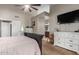 View of main bedroom with en suite bathroom entrance, vaulted ceilings, ceiling fan and neutral colored walls at 650 E Silver Creek Rd, Gilbert, AZ 85296