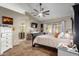 Spacious main bedroom with vaulted ceilings, ceiling fan, en suite bathroom access and a large slider door to outside at 650 E Silver Creek Rd, Gilbert, AZ 85296