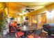 Covered patio with ceiling fans, outdoor furniture, and a view of the interior through sliding glass doors at 650 E Silver Creek Rd, Gilbert, AZ 85296