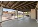 Covered back patio area with an outdoor grill, fireplace, and plenty of space at 6751 W Cameron Dr, Peoria, AZ 85345