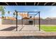 Fireplace with seating area and shade in backyard with rock landscaping at 6751 W Cameron Dr, Peoria, AZ 85345