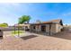 Spacious backyard featuring a covered patio, an outdoor grill, and well kept gravel and turf at 6751 W Cameron Dr, Peoria, AZ 85345