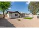 Well kept backyard area with gravel and a covered patio, an outdoor grill, and some turf at 6751 W Cameron Dr, Peoria, AZ 85345