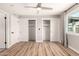 Bright bedroom with light hardwood floors, ceiling fan, and closet with sliding doors at 6751 W Cameron Dr, Peoria, AZ 85345