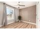 Cozy bedroom with a panel accent wall, light wood floors, and ample natural light at 6751 W Cameron Dr, Peoria, AZ 85345