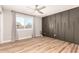 Spacious bedroom with modern accent wall, ample natural light, and a ceiling fan at 6751 W Cameron Dr, Peoria, AZ 85345