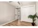 Open bedroom with walk-in closet, wood-look floors, and view to ensuite bathroom at 6751 W Cameron Dr, Peoria, AZ 85345