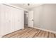 Simple bedroom with wood-look floors, white trim and a double closet at 6751 W Cameron Dr, Peoria, AZ 85345