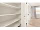 Walk-in closet with adjustable shelving and natural light from nearby window at 6751 W Cameron Dr, Peoria, AZ 85345
