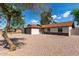 Charming single-story home featuring a gray brick garage and low maintenance rock landscaping at 6751 W Cameron Dr, Peoria, AZ 85345