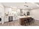 Well-appointed kitchen with white cabinetry, stainless appliances and large island with seating at 6751 W Cameron Dr, Peoria, AZ 85345