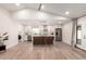 Bright, open kitchen with a large island, stainless steel appliances and adjacent laundry room at 6751 W Cameron Dr, Peoria, AZ 85345