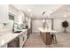 Bright kitchen with stainless appliances, sleek cabinetry, and ample counter space overlooking the living area at 6751 W Cameron Dr, Peoria, AZ 85345