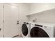 Laundry room featuring a full size washer and dryer with shelf and a door at 6751 W Cameron Dr, Peoria, AZ 85345