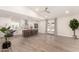 Open-concept living room and kitchen featuring modern updates and wood-look tile floors at 6751 W Cameron Dr, Peoria, AZ 85345