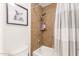 A clean bathroom features a shower with tiled walls, and a framed painting of an owl at 7008 E Gold Dust Ave # 236, Scottsdale, AZ 85253
