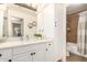 Bathroom featuring a vanity with white cabinets and a shower with a brown tile surround at 7008 E Gold Dust Ave # 236, Scottsdale, AZ 85253