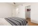 Bedroom with modern bed and striped bedding plus walk-in closet and access to ensuite bath at 7008 E Gold Dust Ave # 236, Scottsdale, AZ 85253
