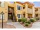 Condominium exterior with a staircase, mature landscaping, and welcoming walkways at 7008 E Gold Dust Ave # 236, Scottsdale, AZ 85253