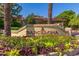 The 'Barcelona' community entrance sign is surrounded by lush landscaping and vibrant flowers at 7008 E Gold Dust Ave # 236, Scottsdale, AZ 85253