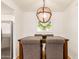 A dining area is staged with a wood table, upholstered chairs, and modern light fixture over a framed art piece at 7008 E Gold Dust Ave # 236, Scottsdale, AZ 85253