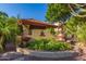 Beautifully landscaped entrance sign surrounded by palm trees and greenery at 7008 E Gold Dust Ave # 236, Scottsdale, AZ 85253