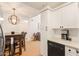 The kitchen opens to the living room, and features white cabinetry, a black dishwasher, and a coffee maker at 7008 E Gold Dust Ave # 236, Scottsdale, AZ 85253