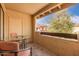 Outdoor patio featuring a glass table and chairs with a view of the neighborhood and trees at 7008 E Gold Dust Ave # 236, Scottsdale, AZ 85253