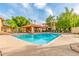Community pool with lounge chairs surrounded by mature trees and lush landscaping, offering a resort-like atmosphere at 7008 E Gold Dust Ave # 236, Scottsdale, AZ 85253