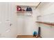 A tidy walk-in closet features multiple shelves, hanging rods, and organized bins with storage at 7008 E Gold Dust Ave # 236, Scottsdale, AZ 85253