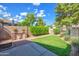Backyard with green grass and patio area with brick fireplace at 715 N Cholla St, Chandler, AZ 85224