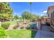 Beautiful backyard with a lush lawn, sparkling pool, and charming outdoor fire pit at 715 N Cholla St, Chandler, AZ 85224
